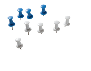Assorted blue and white pushpins scattered