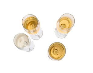 Four champagne flutes filled with light yellow liquid, top-down view