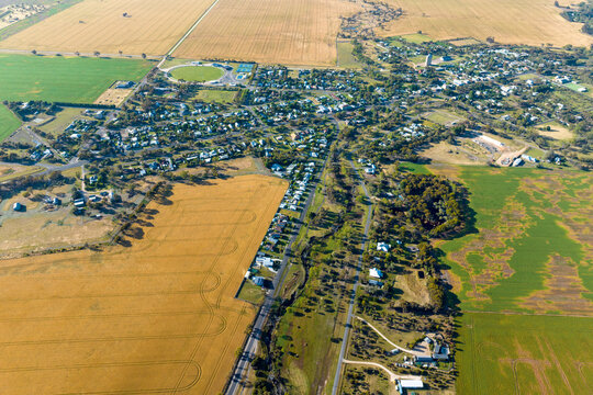 Aerial view of small rural town surrounded by farmland