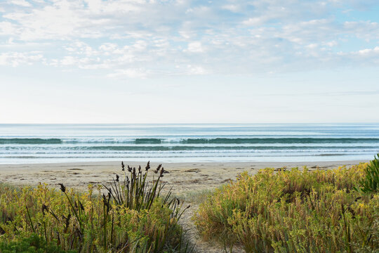 Sandy path to ocean beach and early morning light