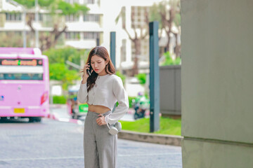 Frustrated Asian Woman Talking on Smartphone in Urban Area