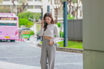 Frustrated Asian Woman Talking on Smartphone in Urban Area