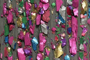 Close-up of colorful, crushed pigments on dark surface