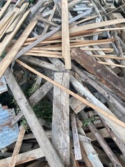 Pile of old wooden planks stacked for construction background