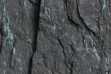 Close-up of dark gray rock face with teal veins
