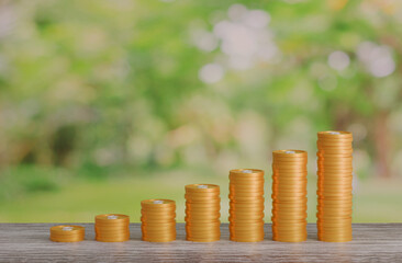 gold coin stacking 3D render on wodden board with photo of green blur nature background for business concept financial, banking and investment with money growth success.