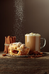 Vienna strudel and caffe latte on an old wooden table.