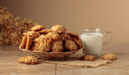 Oatmeal cookies and milk on a kitchen table.