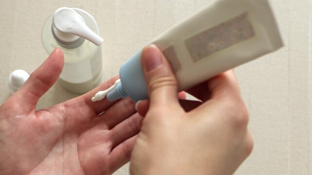 Two fingers rule sunscreen cream applying to female hand. Beige minimal and clean beauty concept, skincare, self-care routine