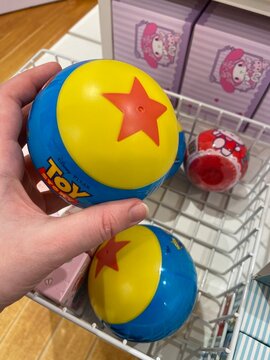 Disney Pixar Toy Story colorful ball with red star design held in hand in Miniso, playful nostalgic collectible item