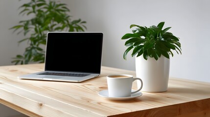 A modern, minimalist workspace with a laptop, a potted plant, and a cup of coffee placed on a wooden desk, creating a calm and productive atmosphere.