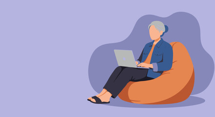 Senior woman comfortably working on a laptop while sitting on a bean bag chair. Illustrates modern remote work, online learning, or digital leisure time.
