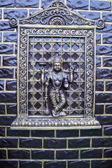 A wall Mural art of Mythological Hindu God Vishnu sculptured in fiber and plaster of Paris and worshipped across India by Hindus.
