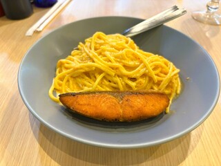 Golden grilled salmon paired with rich spaghetti