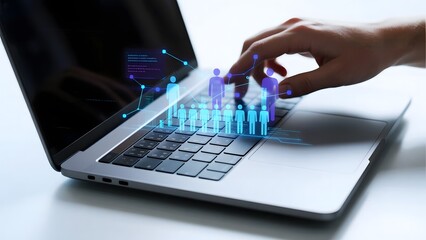 Hand interacting with holographic human figures displayed above a laptop keyboard