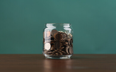 Saving coins in a piggy bank, building good financial discipline, financial planning and investing for the future.