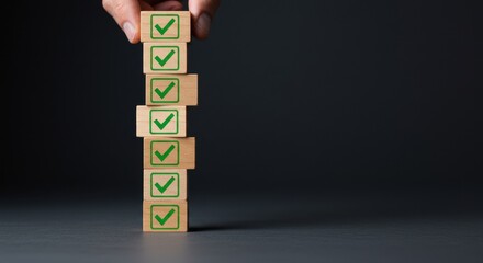 Hand stacking wooden blocks with green check marks, illustrating task completion and success