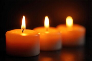 Close-up of three flickering candle flames, casting warm, inviting light against a dark background Perfect for relaxation, spa, or romantic themes , evening, shadow, serenity