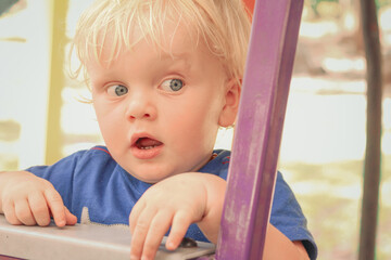 Toddler boy with silly expression at the playground