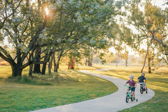 Children riding bikes along walking track in natural Australian bush setting