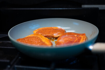 pan with pork fillets cooking
