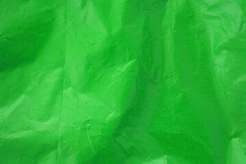 Fototapeta premium Texture of Green color plastic bag smooth crumpled surface