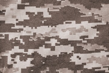 Texture of Dark green pixel camouflage military uniform textile cloth with folds