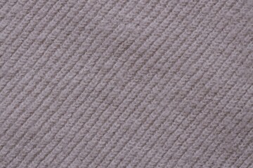 Texture of knitted pastel pink sweater, close-up texture of beige pink
