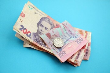 Ukrainian money bills on light blue paper background