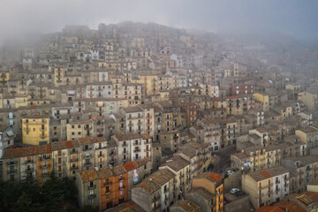 Sunrise view of the rooftops of Gangi with morning fog. Sicily, Italy. August 2024. Aerial drone picture.