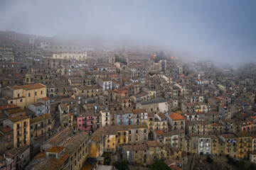 Sunrise view of the rooftops of Gangi with morning fog. Sicily, Italy. August 2024. Aerial drone picture.