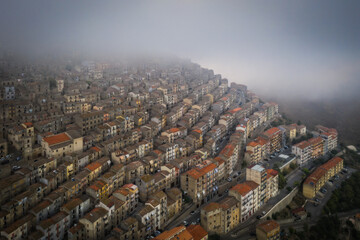 Sunrise view of the rooftops of Gangi with morning fog. Sicily, Italy. August 2024. Aerial drone picture.