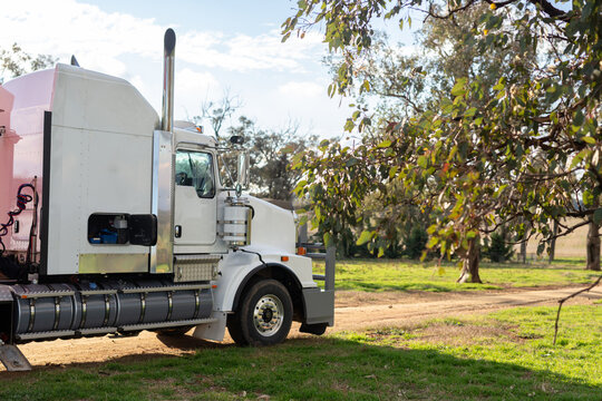 Big white truck with tool box open on a farm