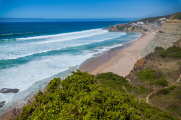 A sweeping coastal panorama featuring a sandy beach