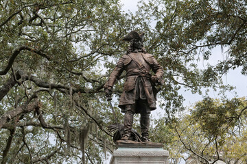 Bronze statue of General James Oglethorpe, founder of Georgia, framed by live oak trees with Spanish moss in historic Chippewa Square, Savannah,  Georgia, USA