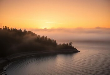Sunrise paints the mist-shrouded Lake Superior at Terrace Bay, Ontario, in soft gold, Canada, clouds