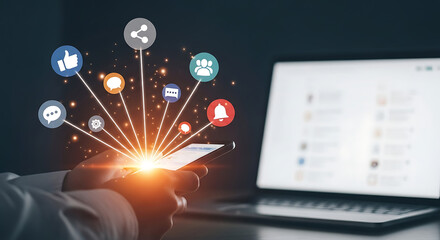 Modern digital marketing concept with smartphone showing social media icons and laptop on dark background