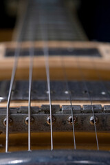 Close-up vintage electric guitar on black background. vertical picture.