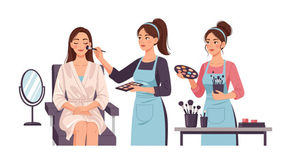 Professional makeup artist applying foundation to a young woman sitting in a chair while another artist holds a palette and brushes