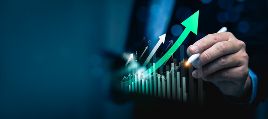 Business growth and financial success concept with businessman hand pointing at rising arrow and...
