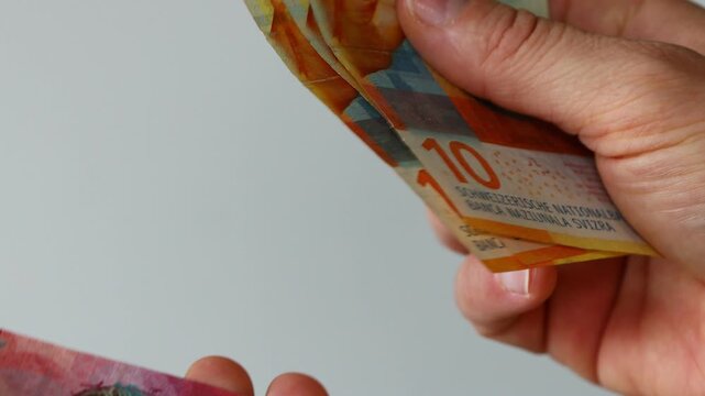 Counting Swiss francs. Close-up. Switzerland, money in hand. Business concept, financial background