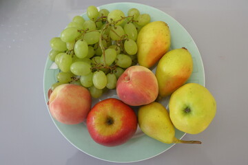 Fruits on a plate on a white background, closeup of photo