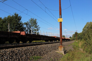 Cargo train transporting metal pipes and tubes 