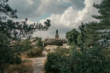 Ancient Statue Surrounded by Forest