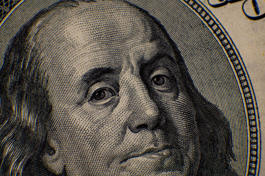 Detailed close-up of a fifty dollar bill showcasing Benjamin Franklin's portrait with intricate engraving