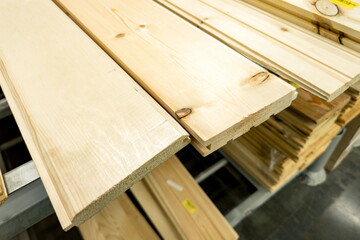 High-quality wooden planks displayed in a lumber yard ready for various construction and DIY projects during the day