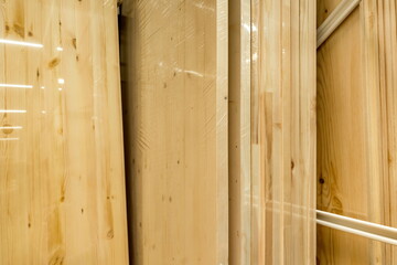 Planks of wood neatly organized on shelves in a construction supply store during daylight hours