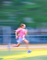 Fototapeta premium teenager girl running in green park. Blur.
