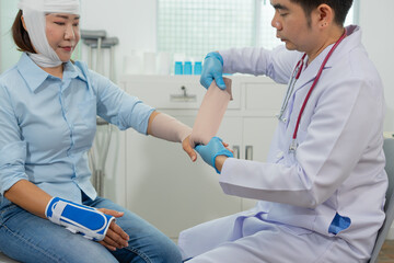 Female patient, head bandage, arm splint, doctor, medical gloves, hospital, injury care