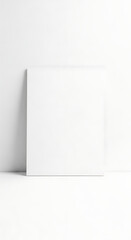 Blank White Square Canvas Leaning Against a White Wall in a Minimalist Studio